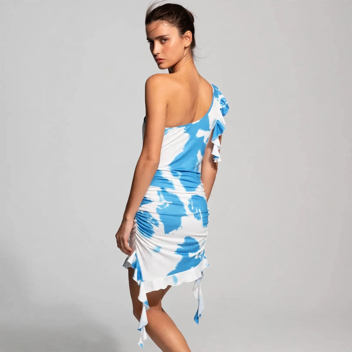 Back view of blue tie-dye ruffled one-shoulder mini dress
