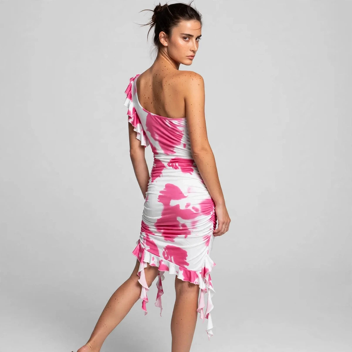 Back view of pink tie-dye ruffled one-shoulder mini dress