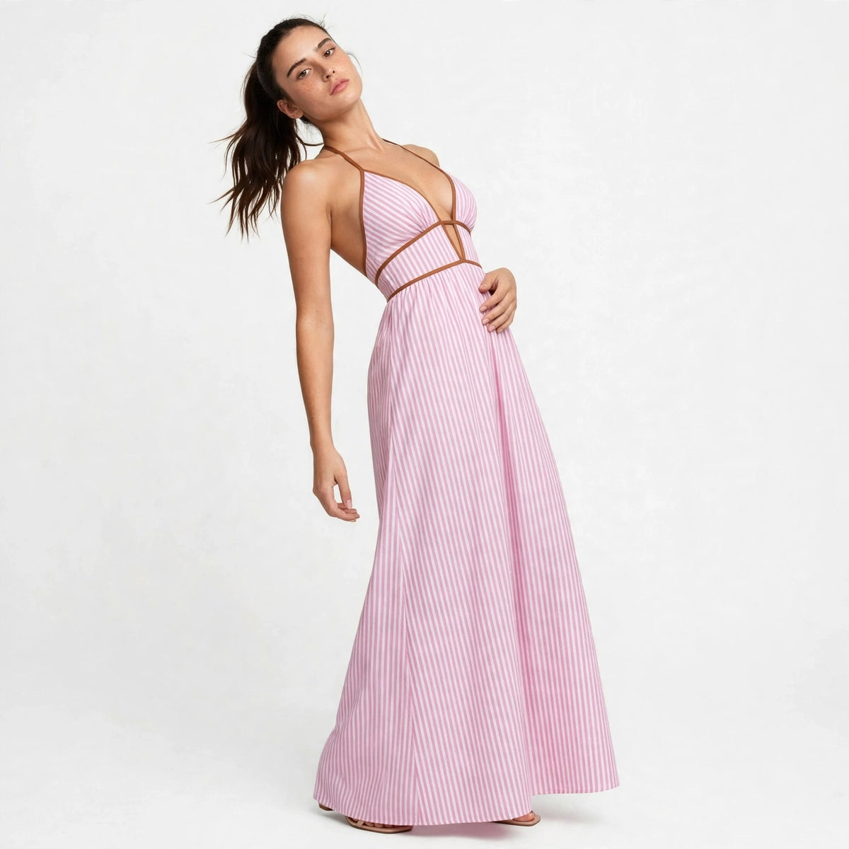 Three-quarter view of pink striped smocked halter maxi dress