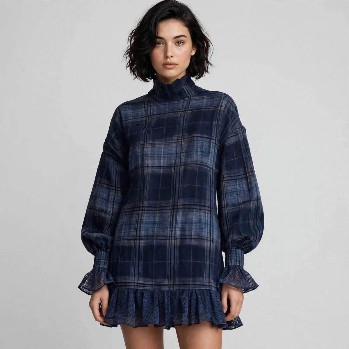 Close-up of navy plaid mini dress showing mock neck and bishop sleeves