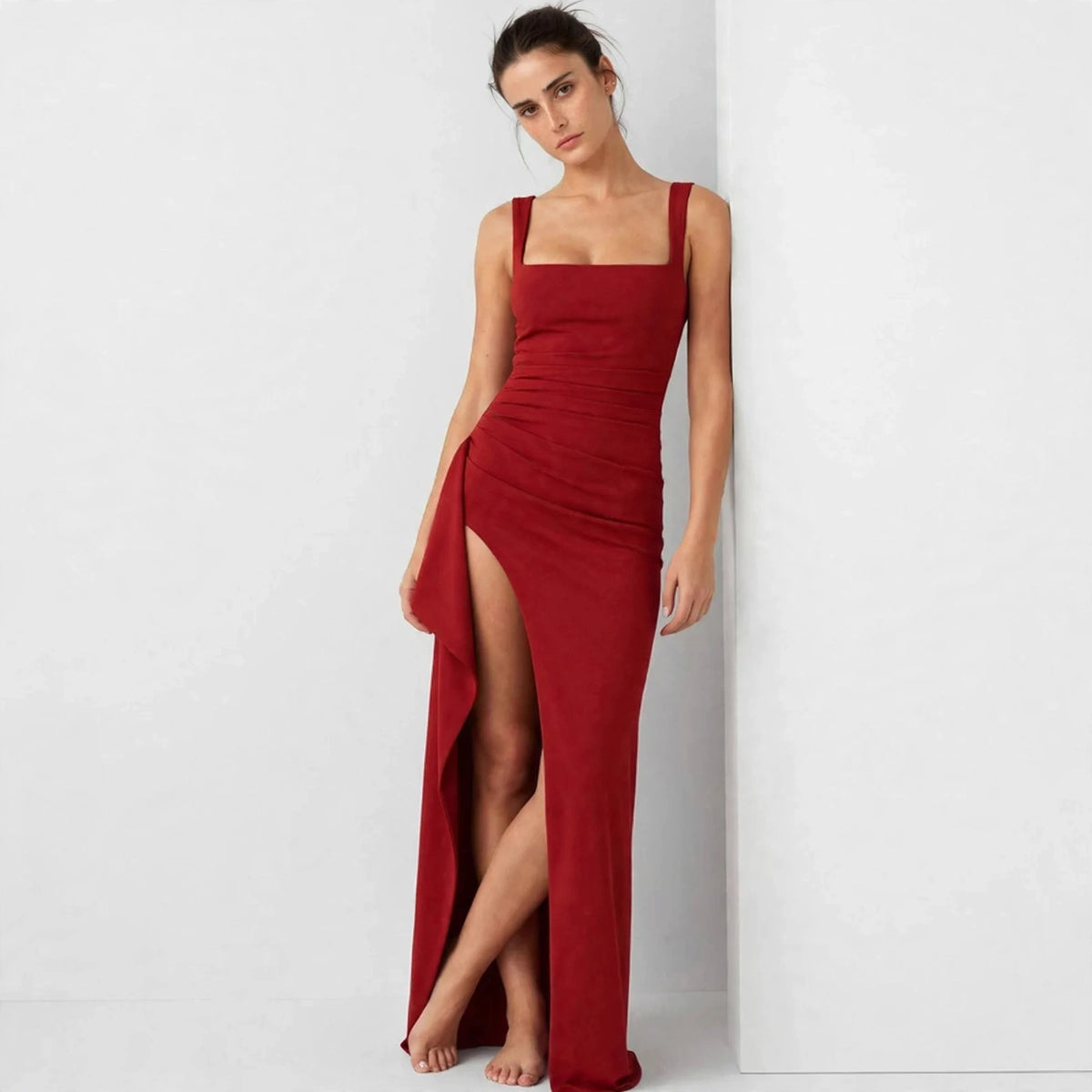red ruched high slit maxi dress – front view, leaning against wall