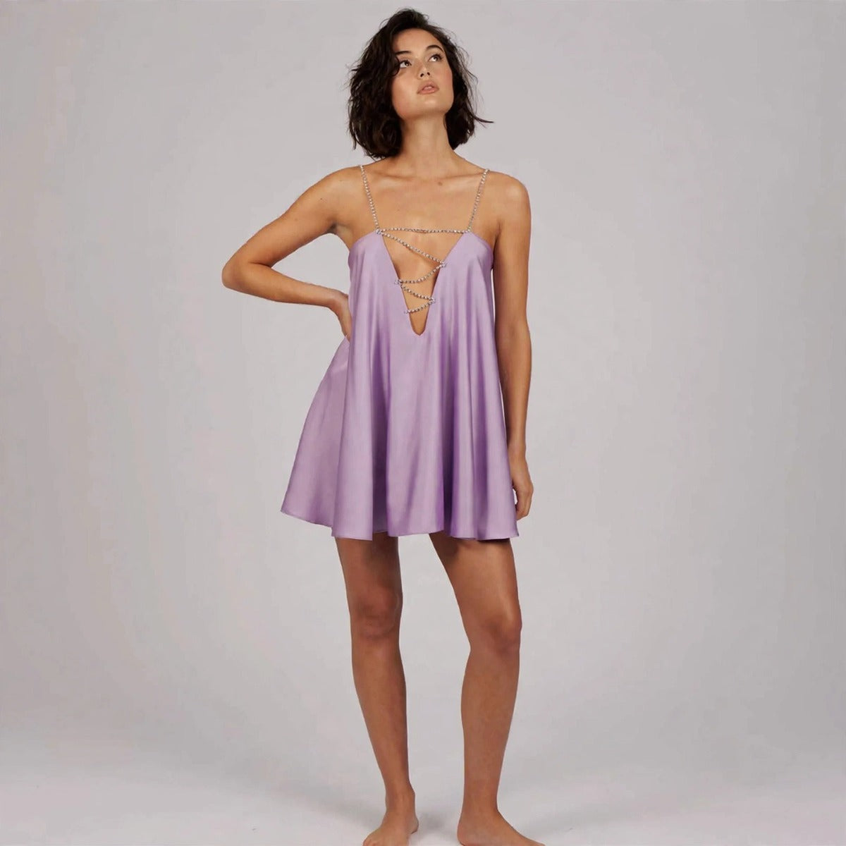 Model wearing lavender rhinestone mini dress in a fashion editorial pose