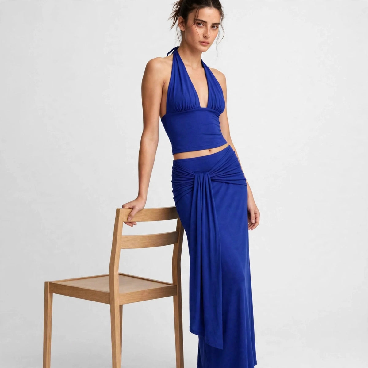 Front view of royal blue halter top and draped maxi skirt set