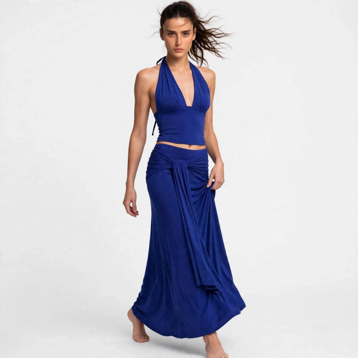 Model wearing royal blue halter skirt set with twisted waist
