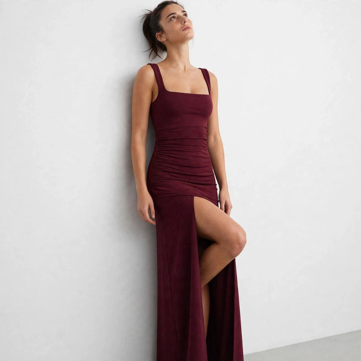 burgundy ruched high slit maxi dress – front view, head tilted back