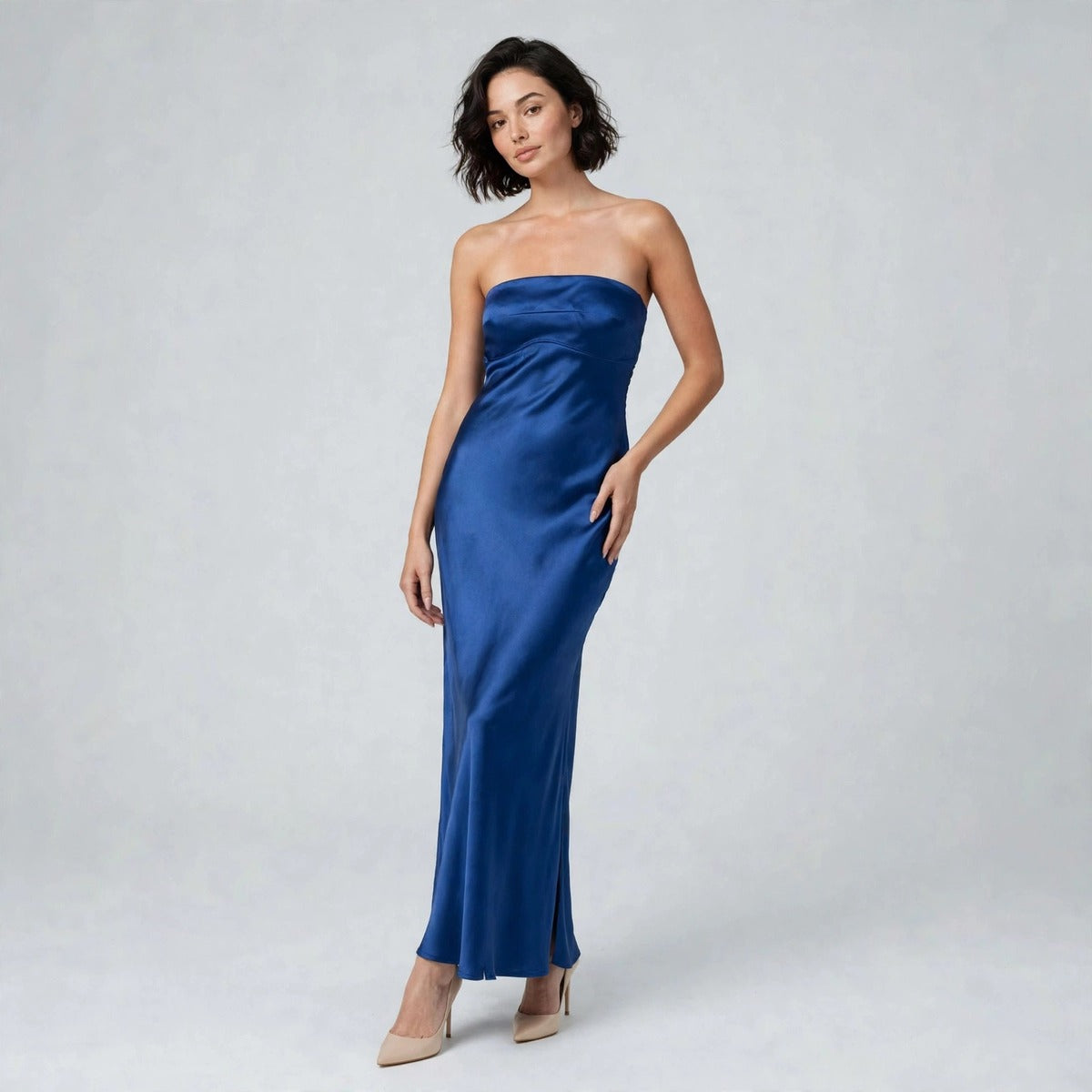 Model wearing royal blue satin strapless tube maxi dress with side slit, front view