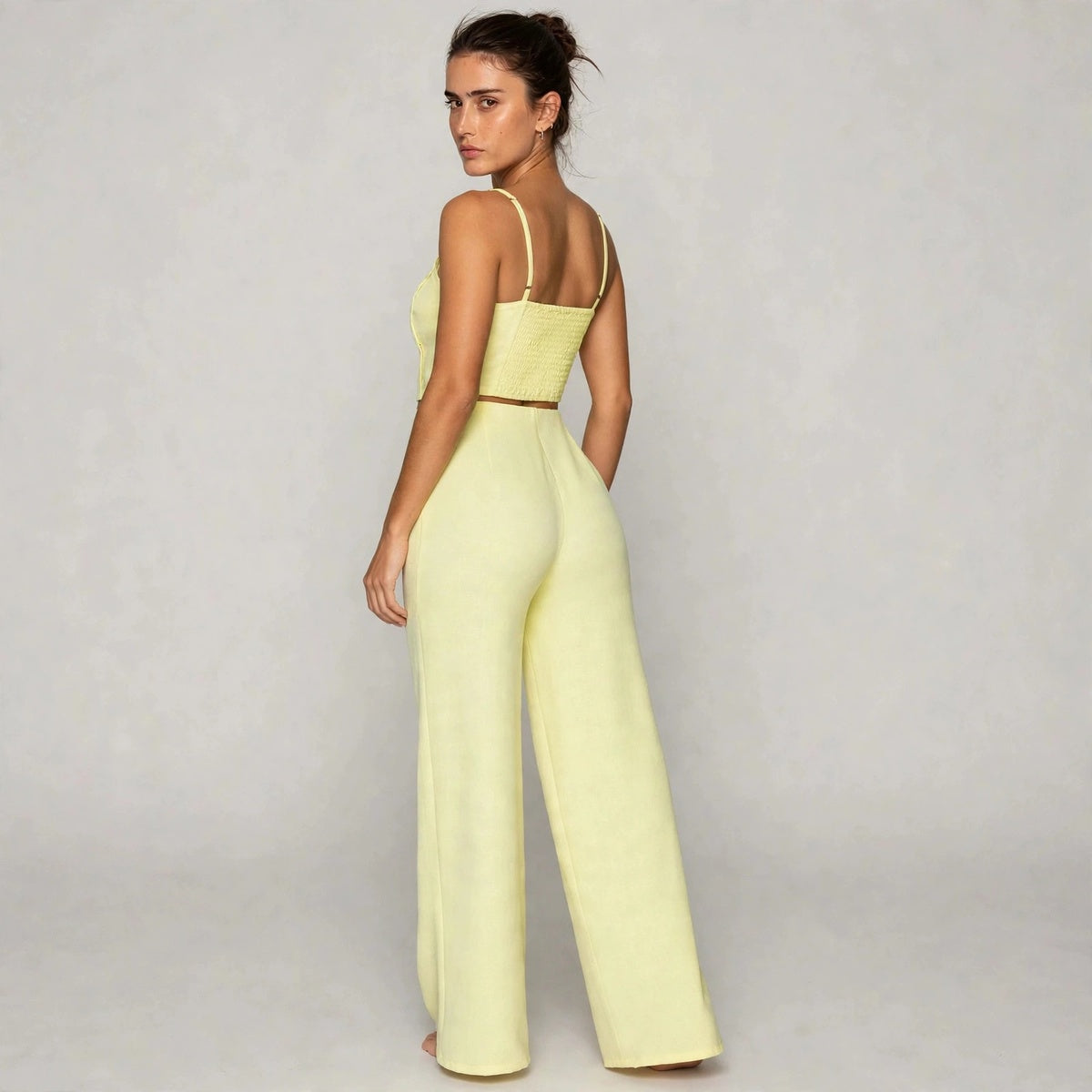 Back view of light yellow smocked cami top with wide-leg pants