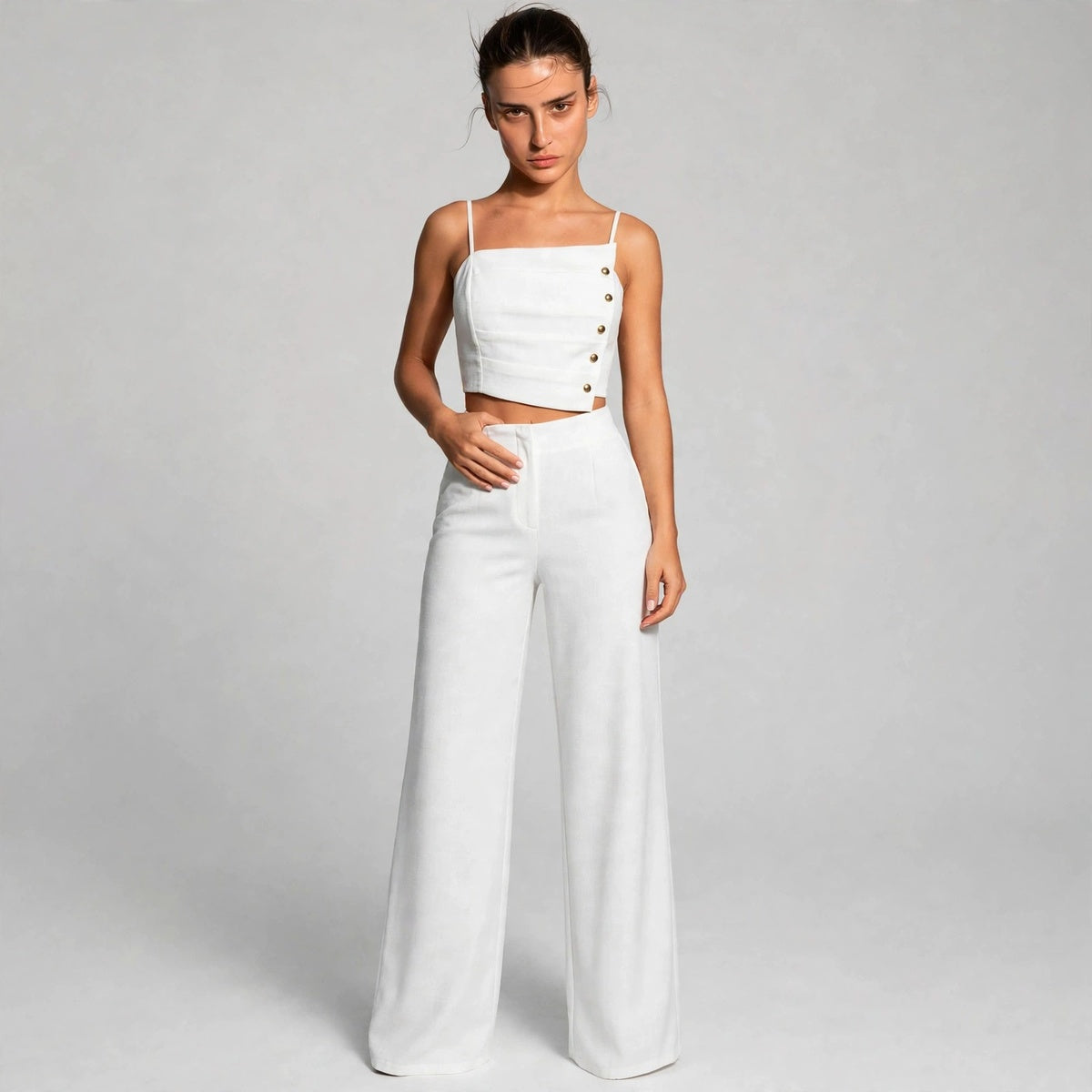 Model wearing white button cami top with wide-leg pants set, front view
