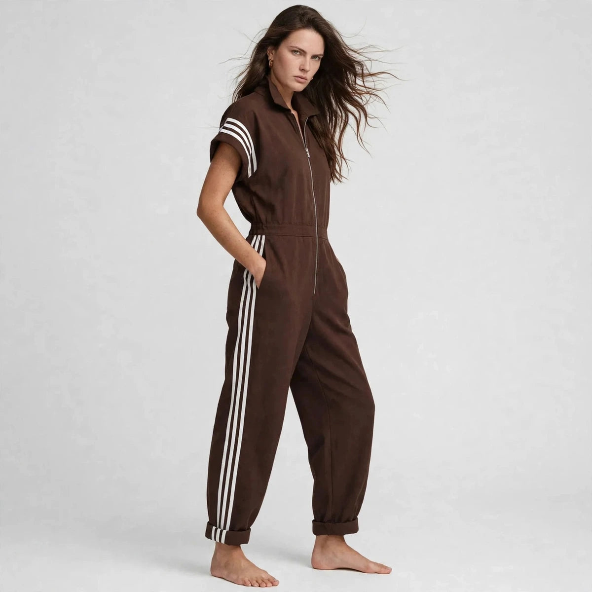 Three-quarter view of brown sporty stripe zip-front jumpsuit with cuffed ankles
