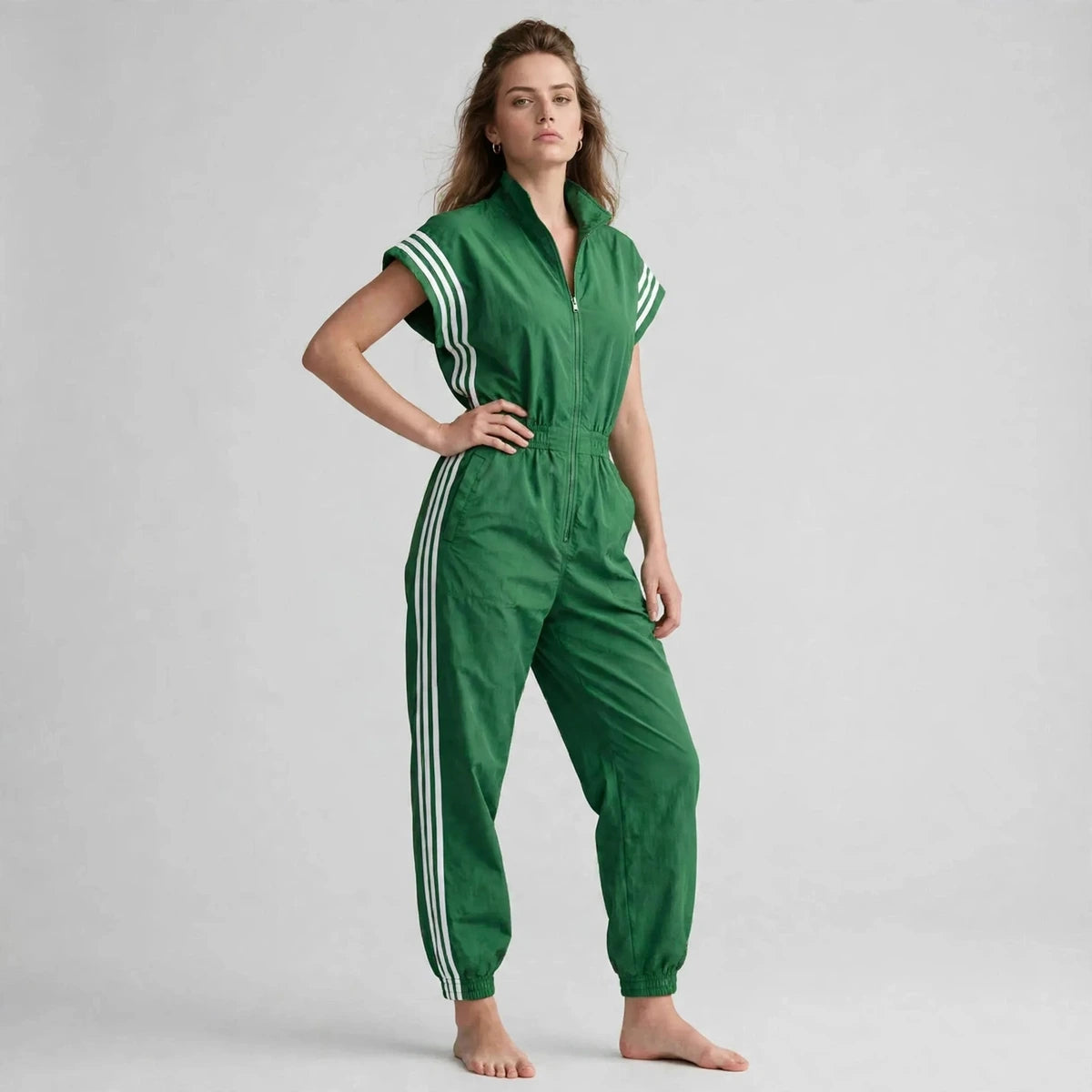 Woman wearing green sporty stripe zip-front jumpsuit with white stripes, front view
