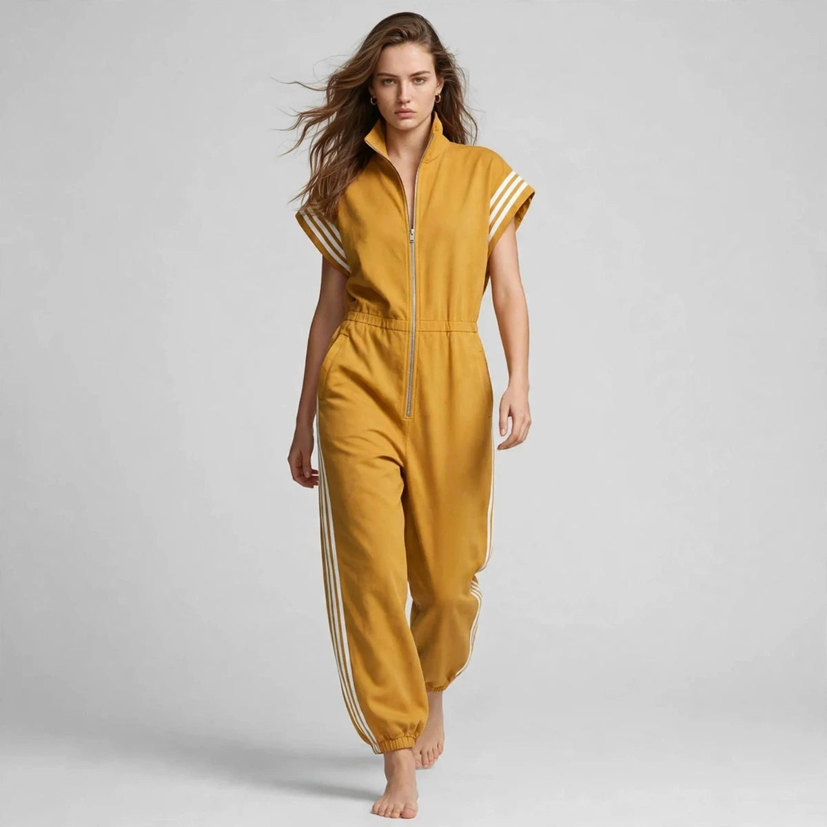 Women's yellow sporty striped jumpsuit, editorial studio shot