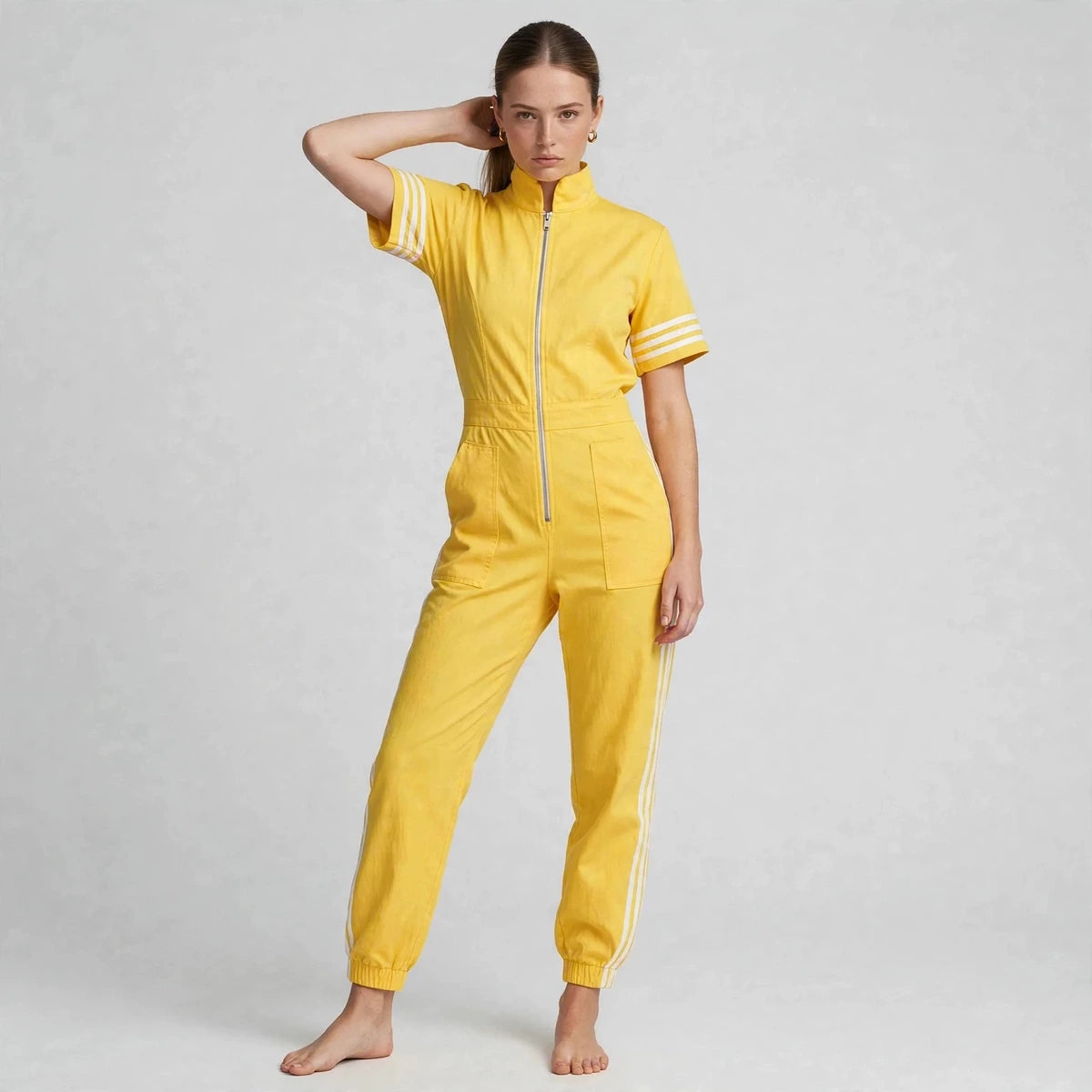 Women's yellow sporty striped jumpsuit, three-quarter view