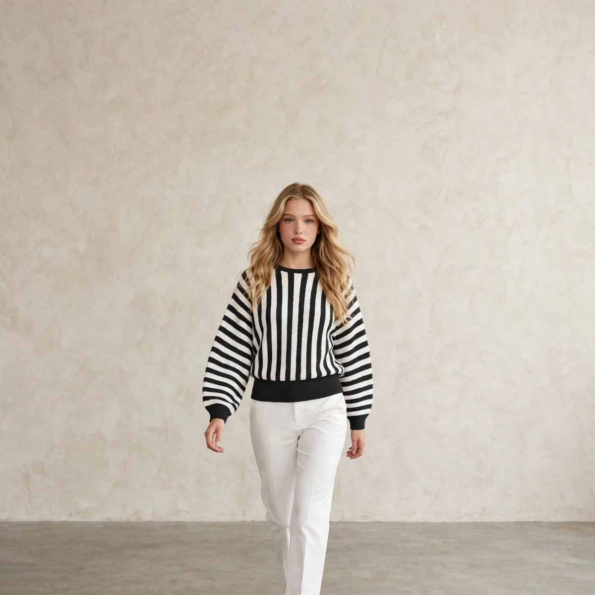 Women's black and white striped crew neck sweater, walking pose