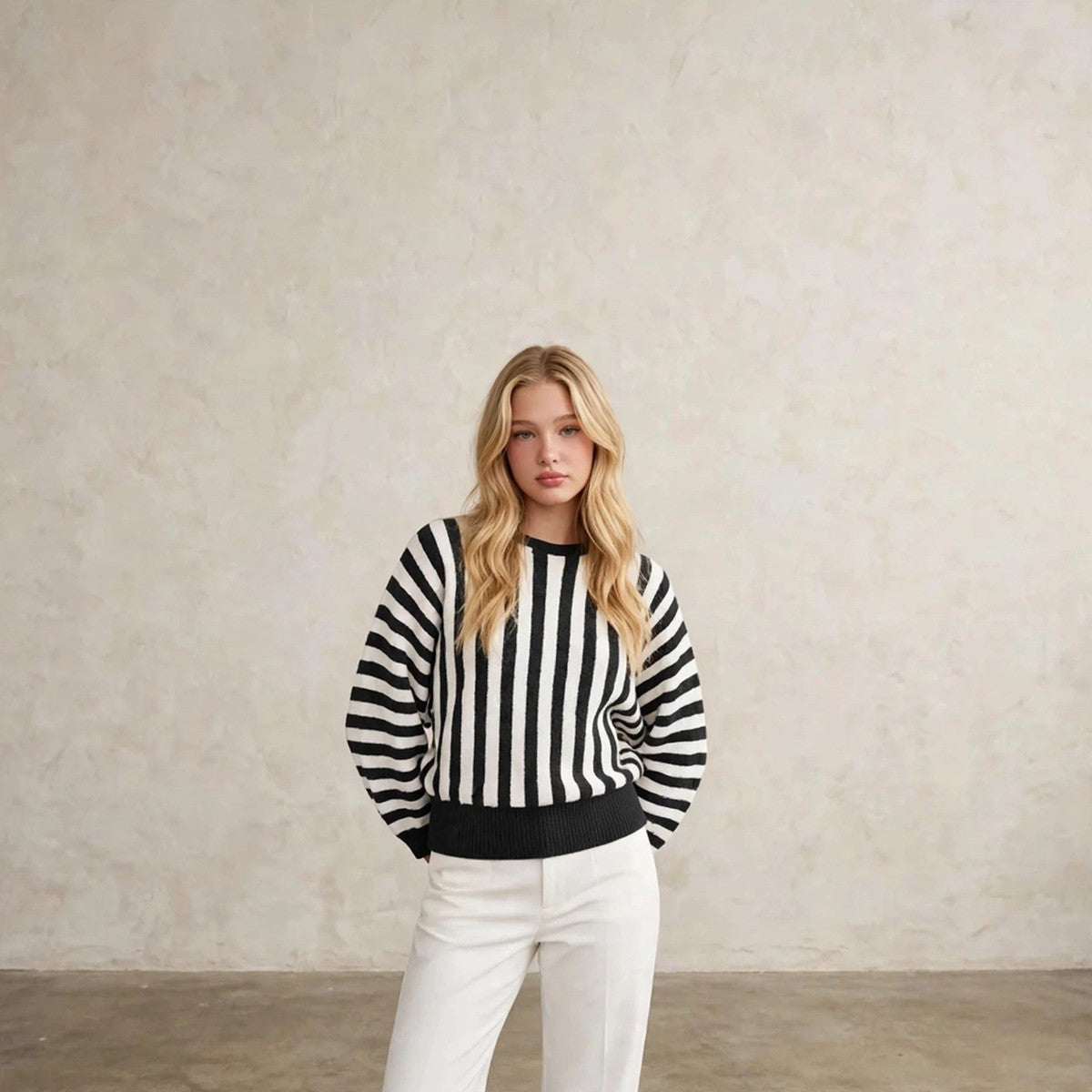 Women's black striped crew neck sweater with hands behind back