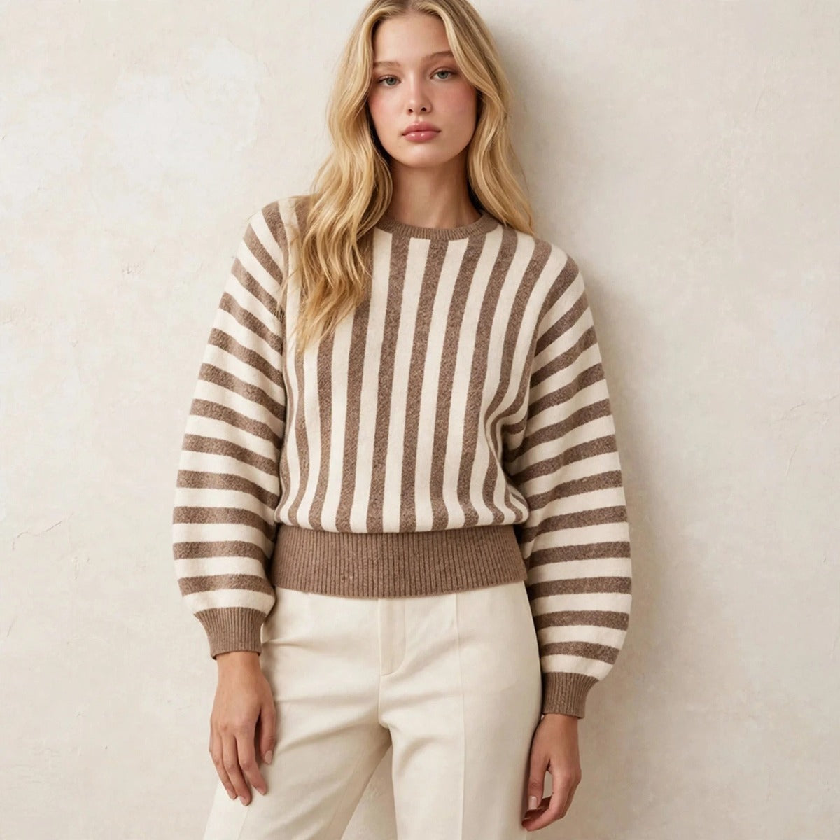 Women's khaki and cream striped sweater, relaxed leaning pose