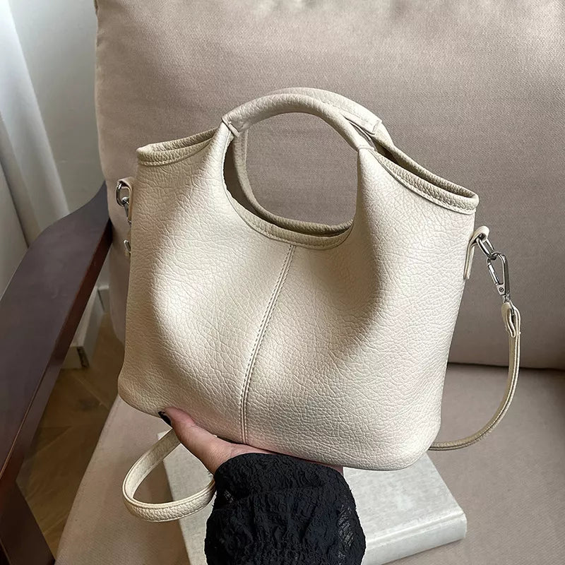 Textured leather crossbody bag with matching pouch close view | Orleve