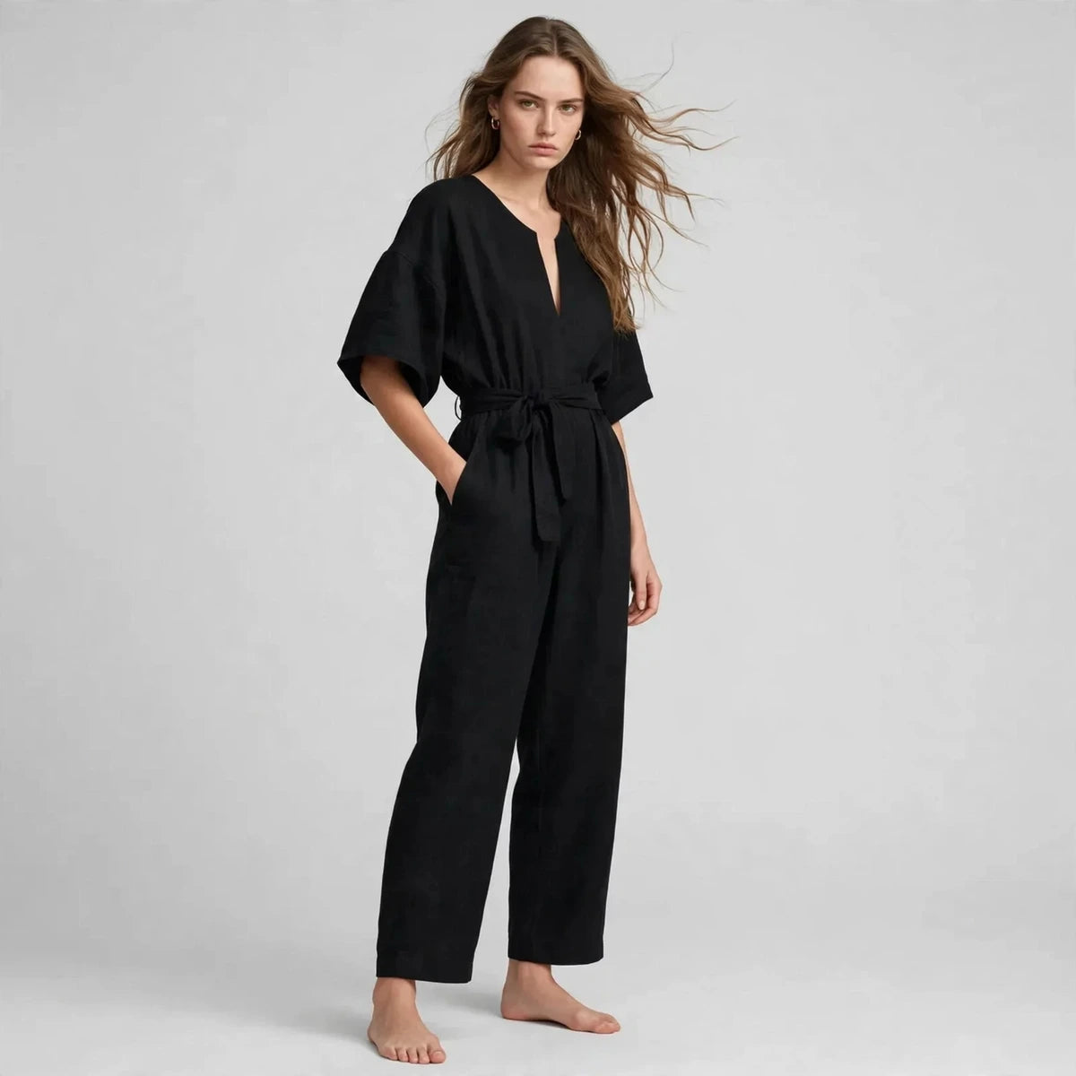 Women's black tie-waist jumpsuit, three-quarter view