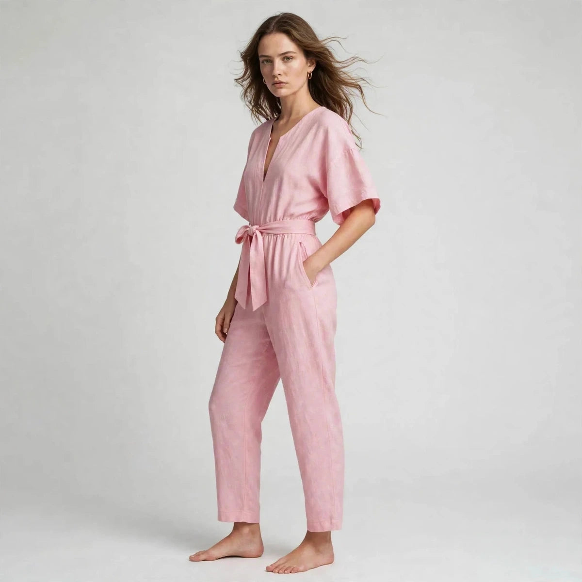 Women's pink tie-waist jumpsuit, three-quarter view