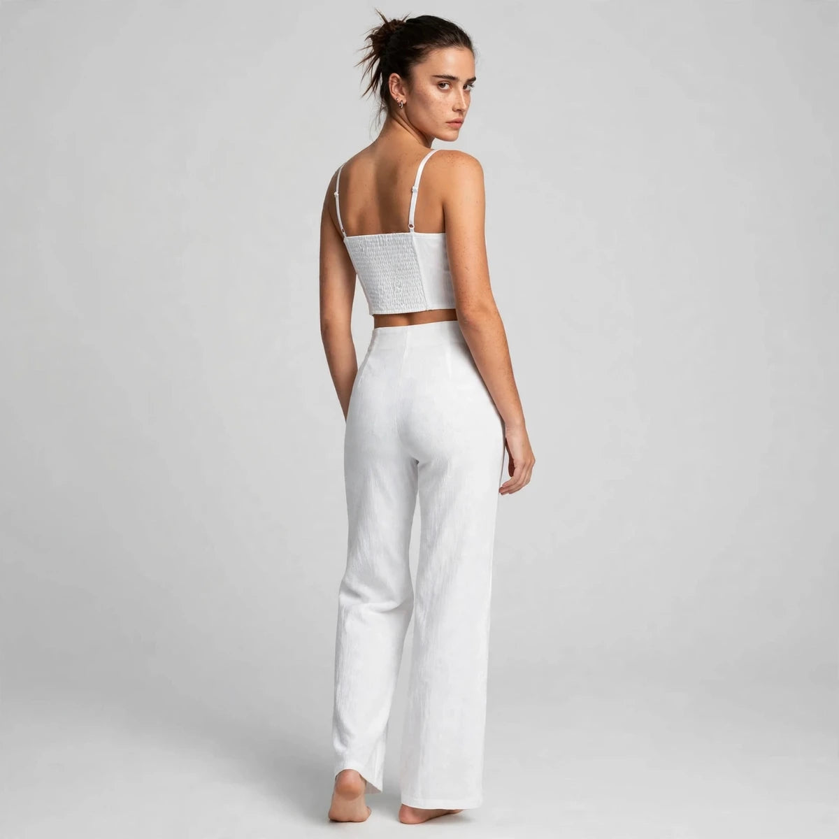 Back view of white smocked cami top with wide-leg pants