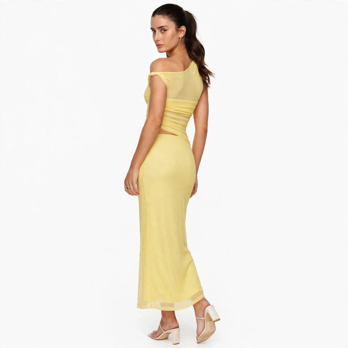 yellow asymmetrical cutout maxi dress – three-quarter back view, looking over shoulder