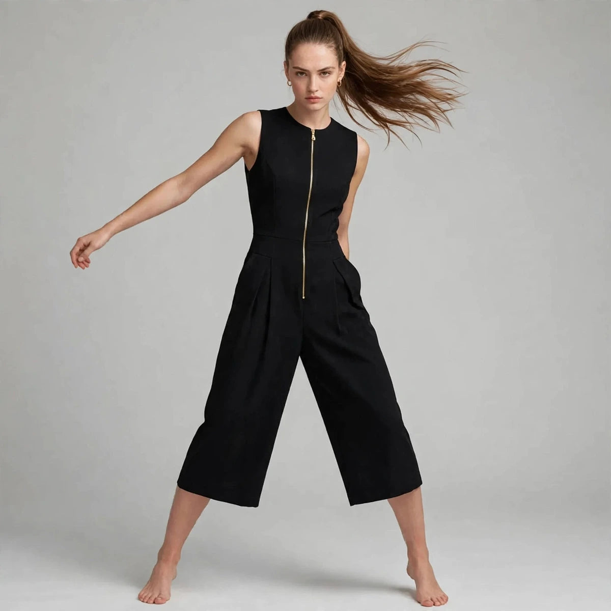 Women's black jumpsuit with zipper pockets, editorial studio shot