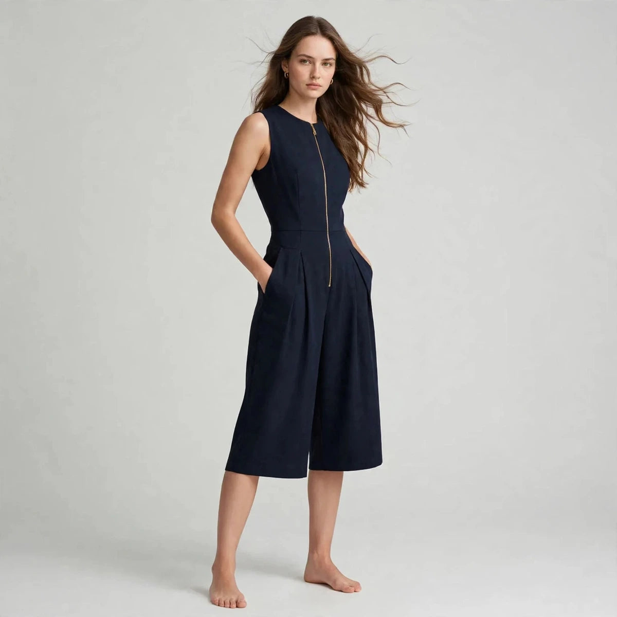 Women's dark blue jumpsuit with zipper pockets, three-quarter view
