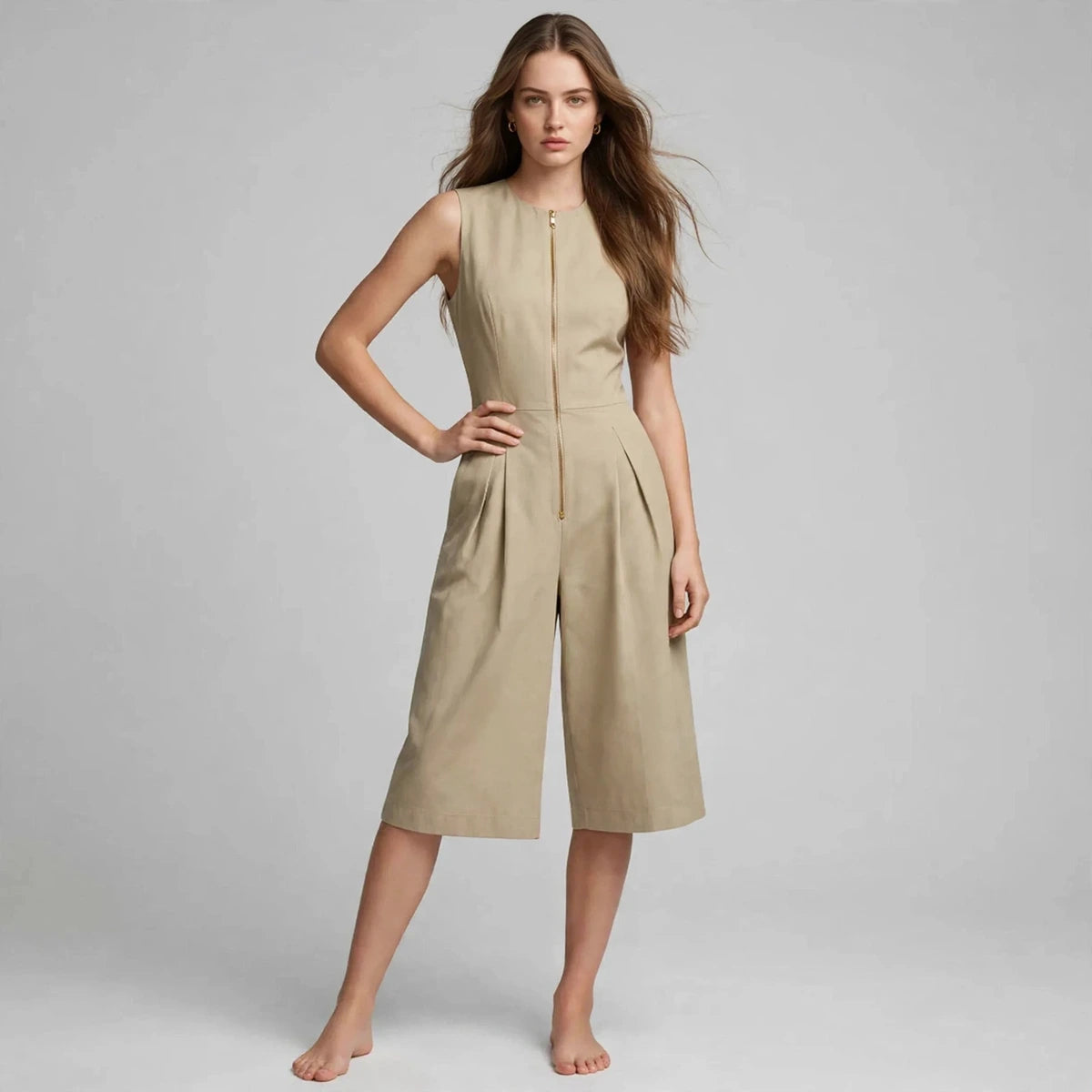 Woman wearing khaki sleeveless jumpsuit with front zipper, front view