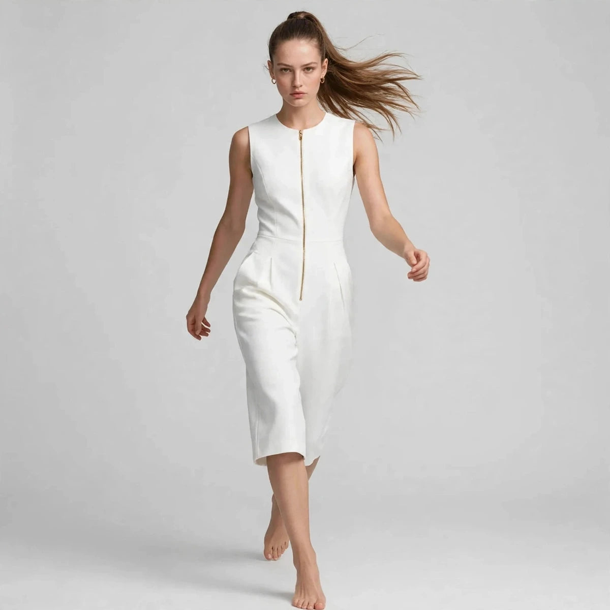 Model wearing white sleeveless zipper pocket jumpsuit in a fashion editorial