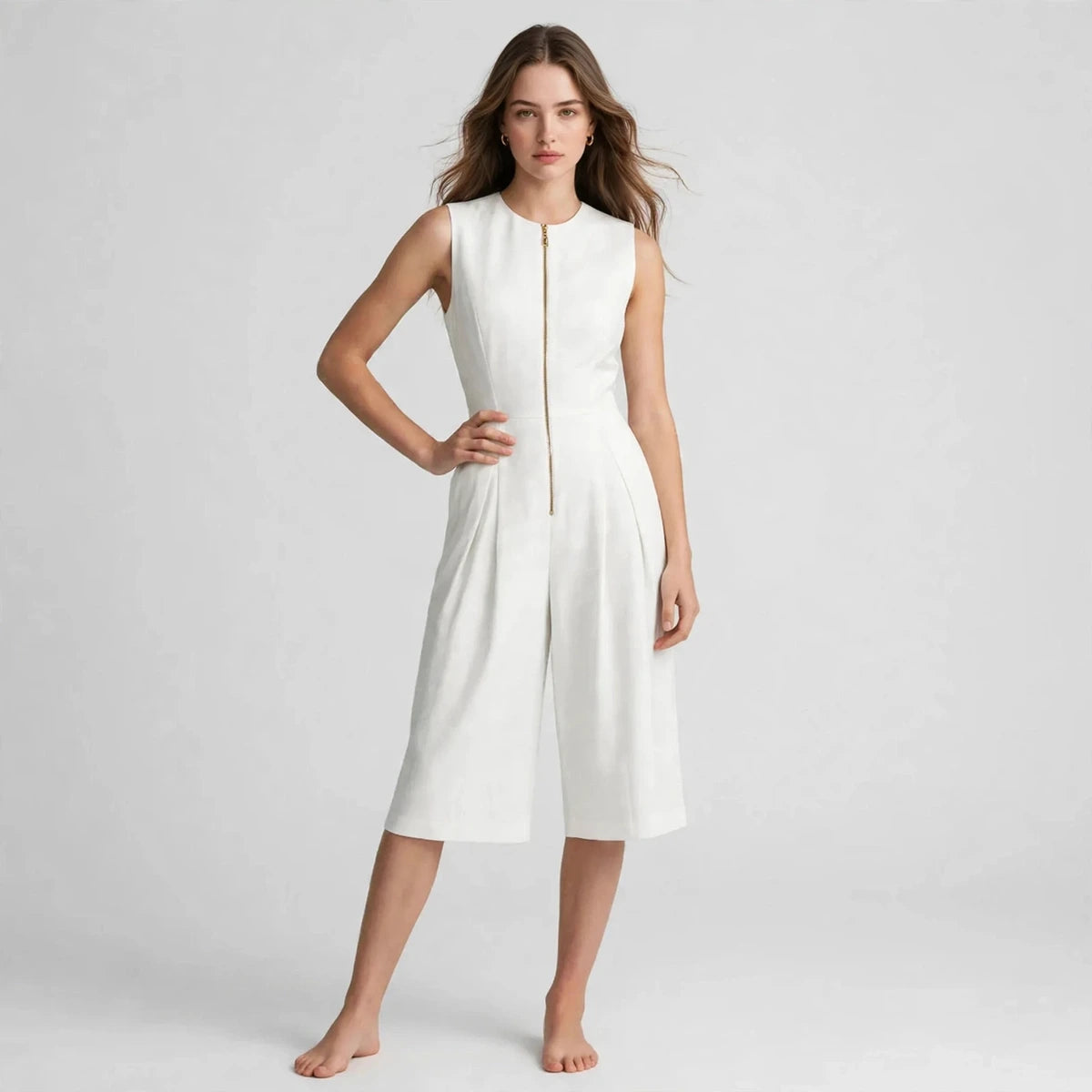 Woman wearing white sleeveless zipper pocket jumpsuit with front zip, front view