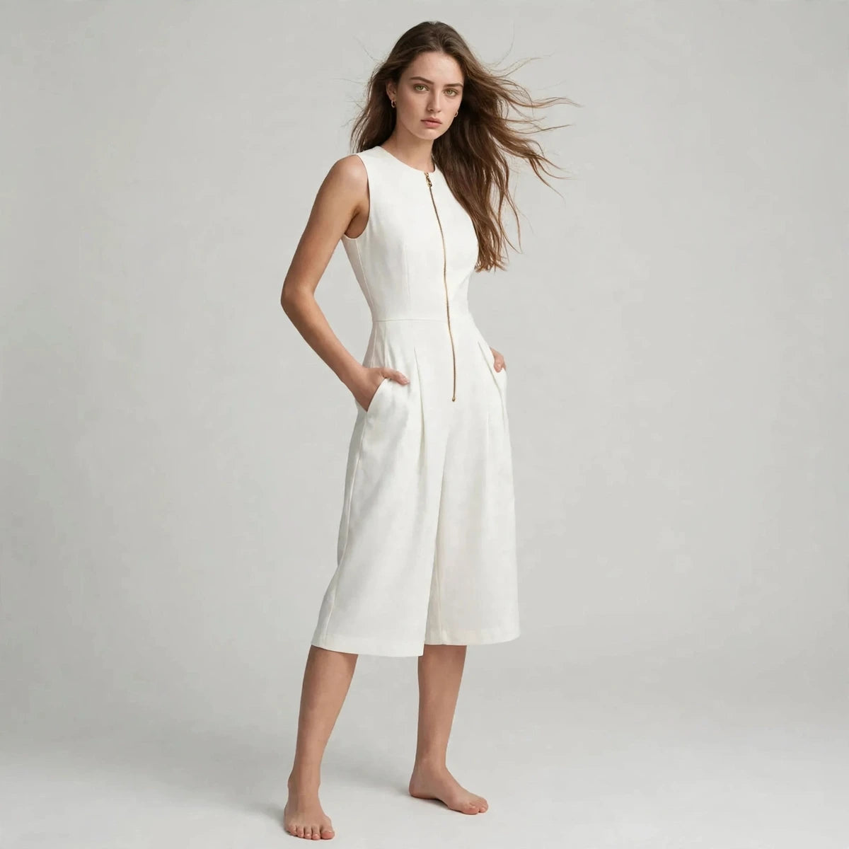 Three-quarter view of white sleeveless jumpsuit with front zipper and side pockets