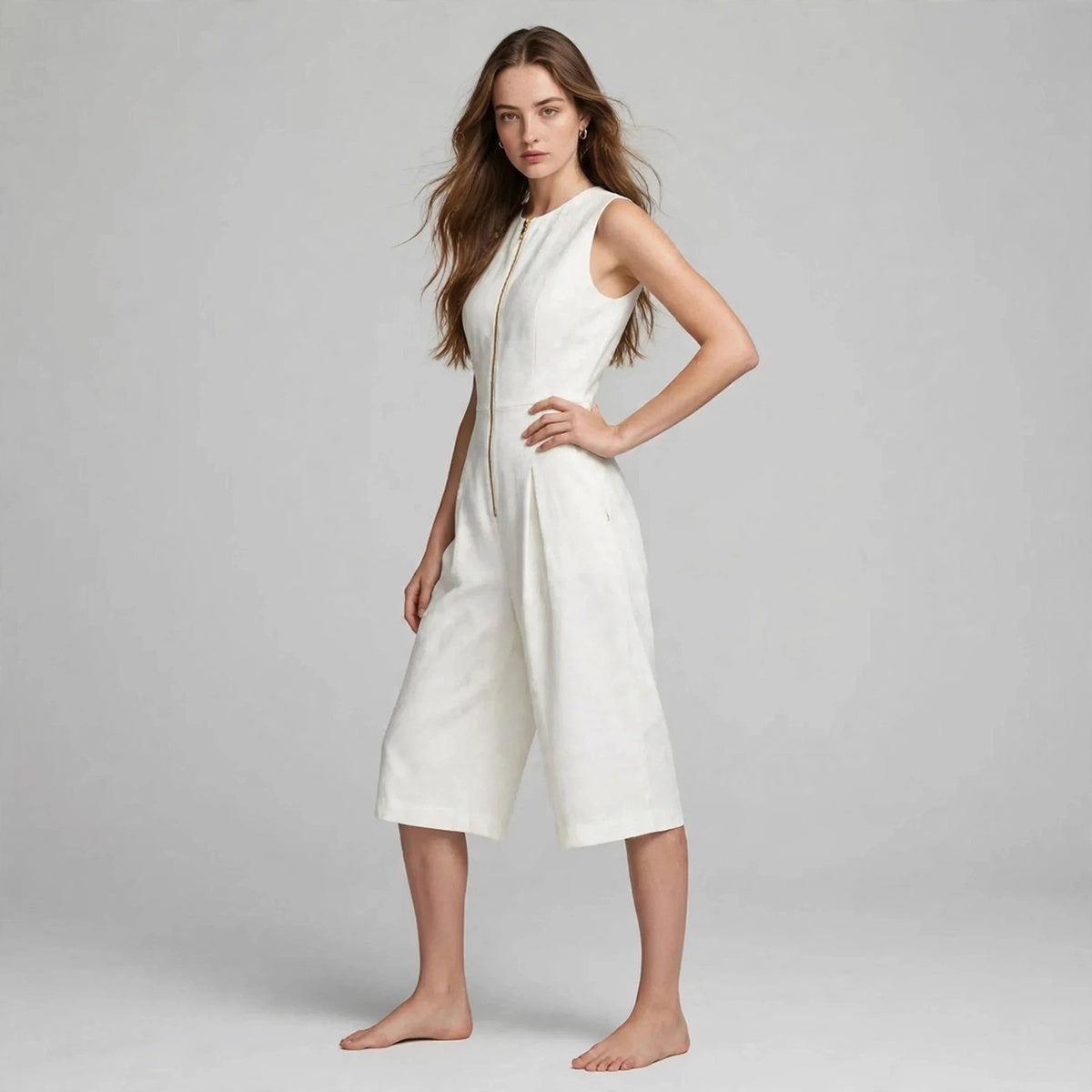 Side view of white sleeveless jumpsuit with exposed front zipper